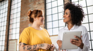 Mulheres alinhando expectativa no trabalho para aumento de bem-estar.